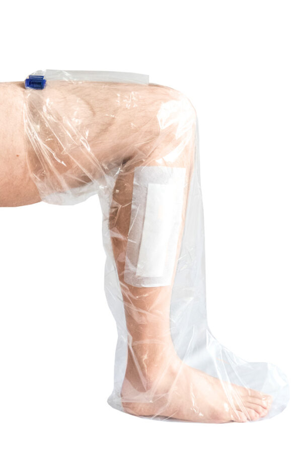 A person with a waterproof sleeve dressing on the leg and foot