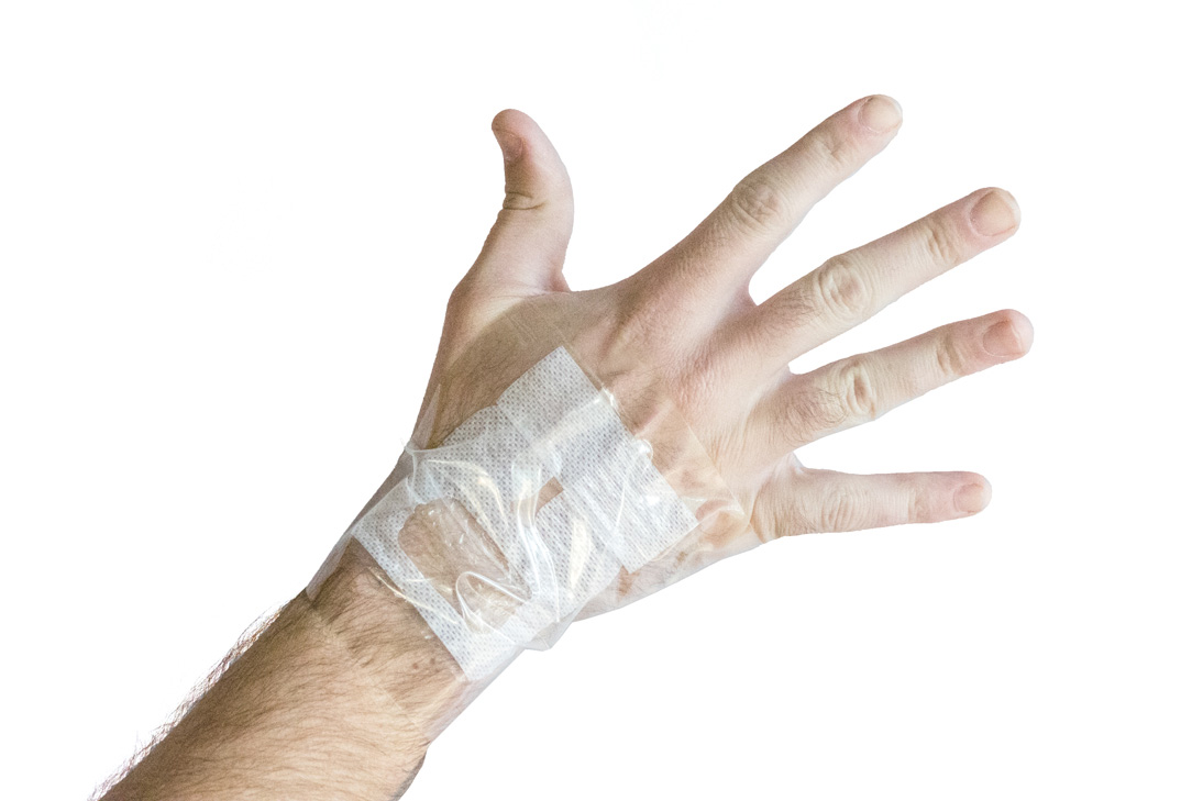 A person with a waterproof dressing on the hand